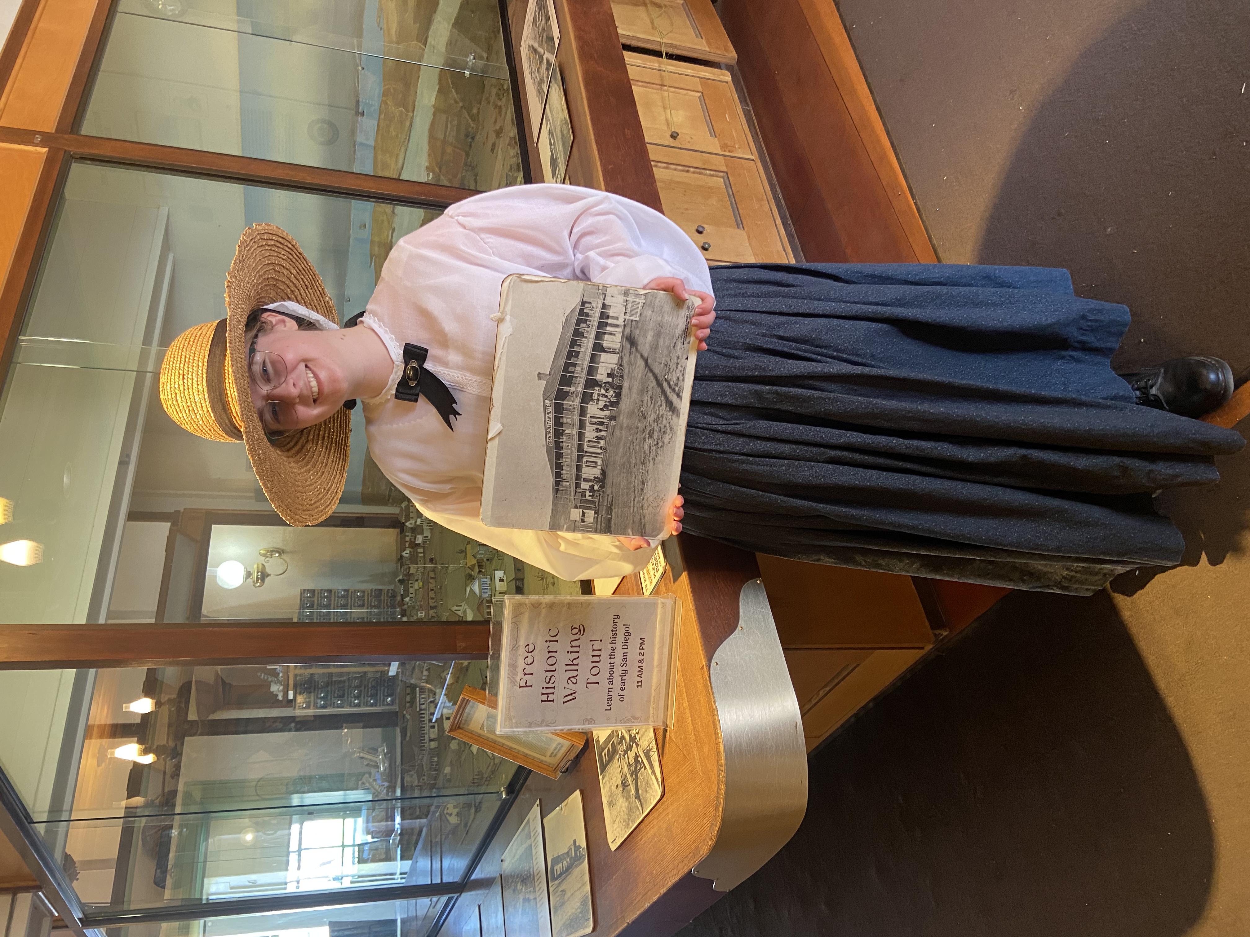 Park staff holing walking tour sign